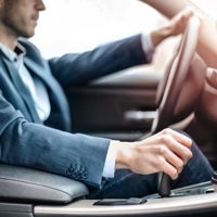 close up of businessman driving a car