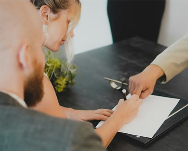 a woman and man signing a document