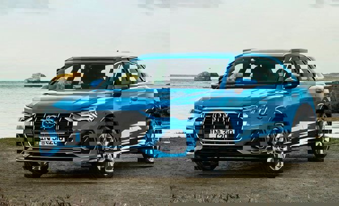 The exterior of a Audi Q3 parked on a street.