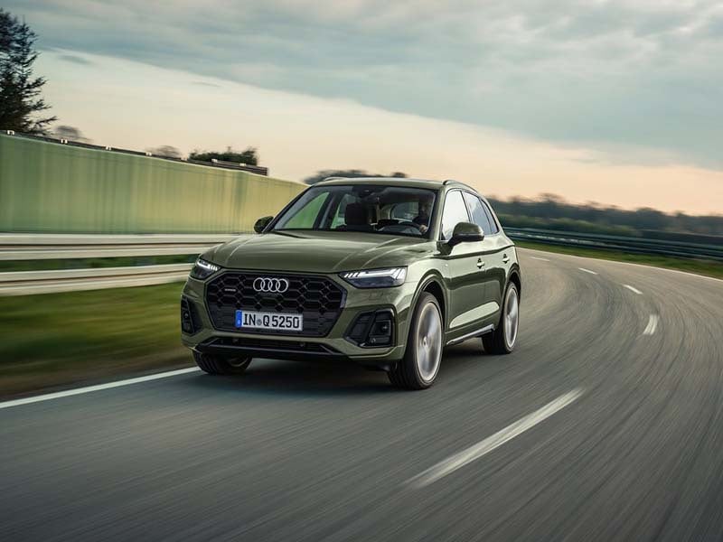 green audi q5 estate driving on the road