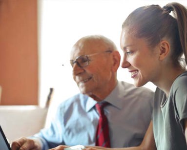 man and woman looking at laptop