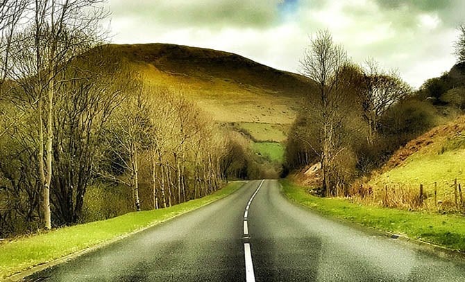 A photo of the Brecon Beacons in Wales, showing a mountain range and green valleys.