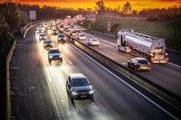 cars stuck in traffic on a motorway during sunset