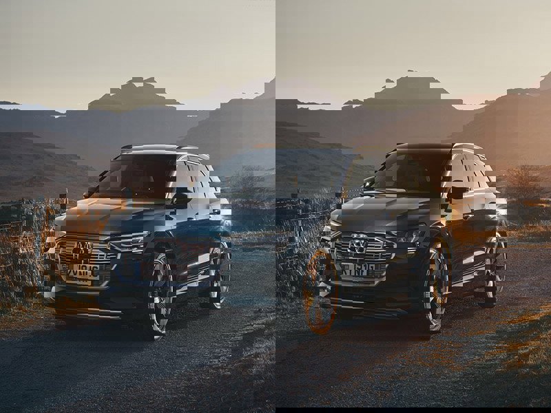 black audi e-tron estate on dirt road