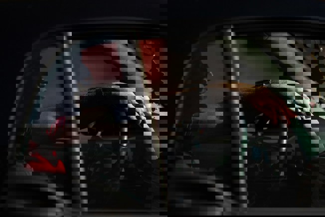 Person sitting in vehicle at night