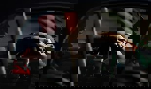 Person sitting in vehicle at night