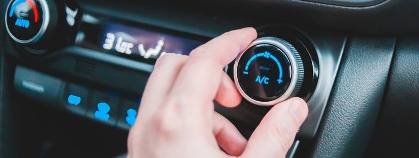 person turning up air conditioning in car