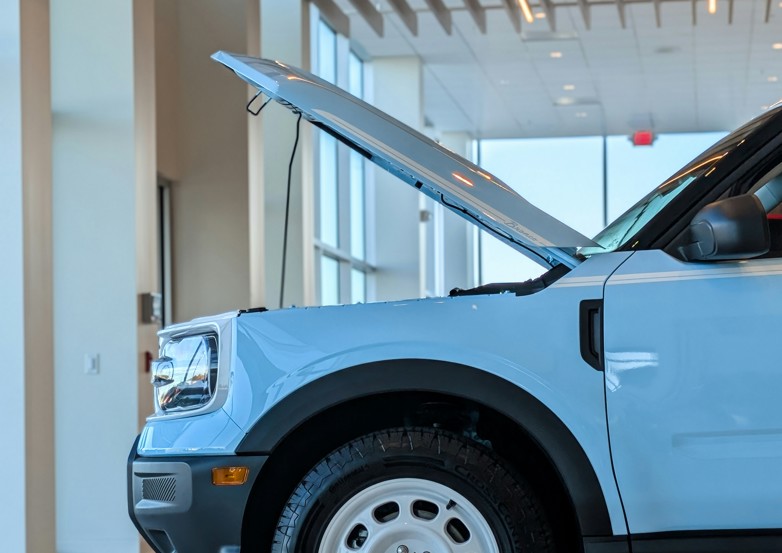 light blue suv with bonnet open