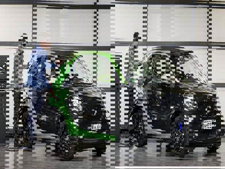 black smart fourtwo coupe ev being charged