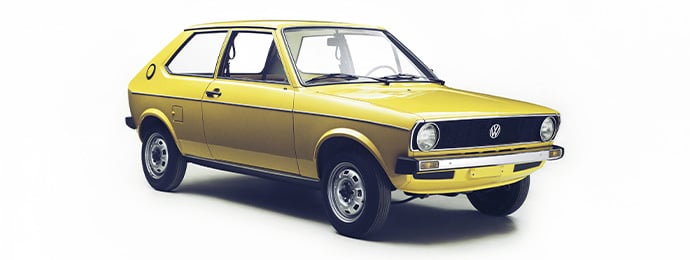 Studio shot of a classic yellow first-generation Volkswagen Polo from the 1970s