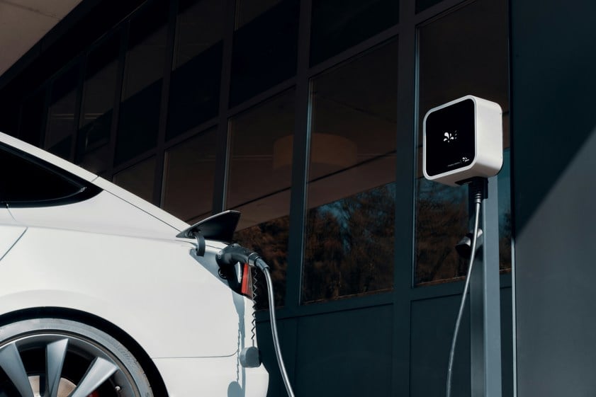 a white car plugged into a charging station