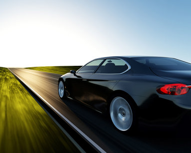 Car driving on a sunset road