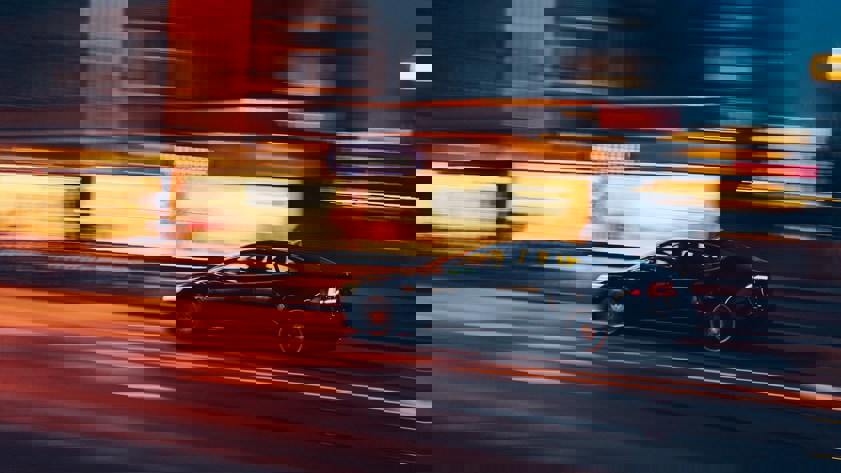 Saloon car driving at night with time span effect