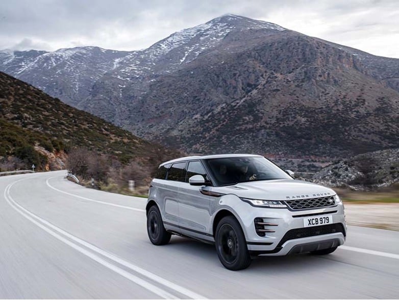 grey range rover evoque driving on road