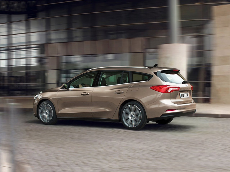 beige ford focus estate side on view