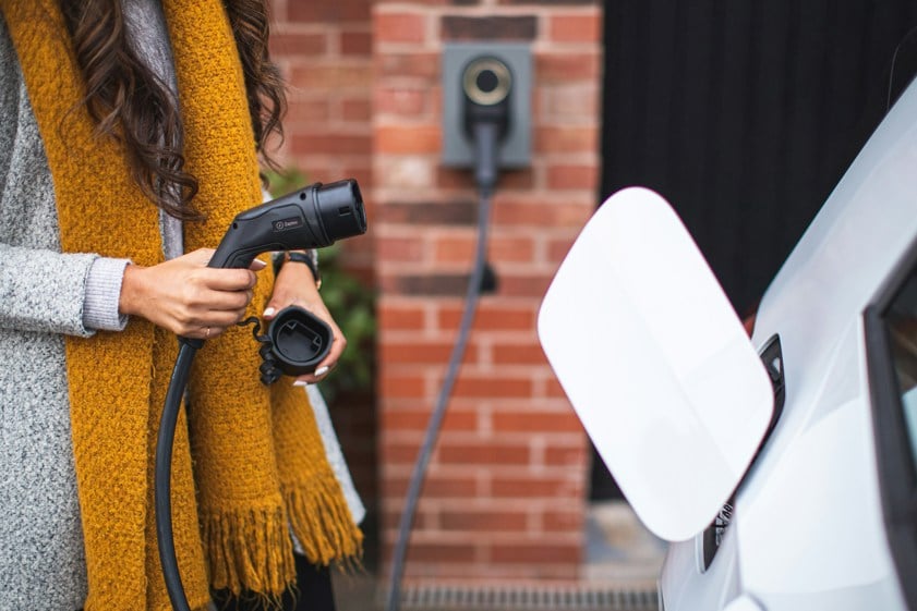 a woman charging ev