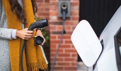 a woman charging ev