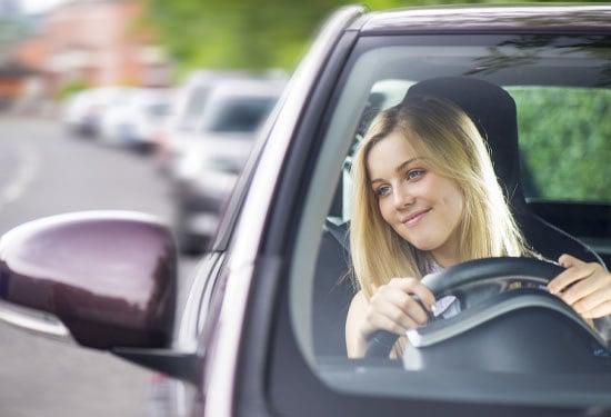 Young woman driving her city car