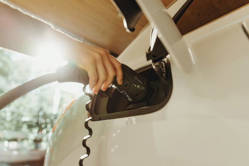 Person charging an electric car at home