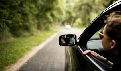 woman with head outside car window