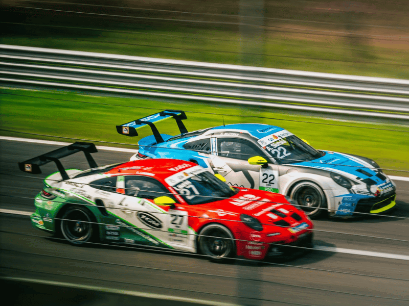 Two race cars racing on a track
