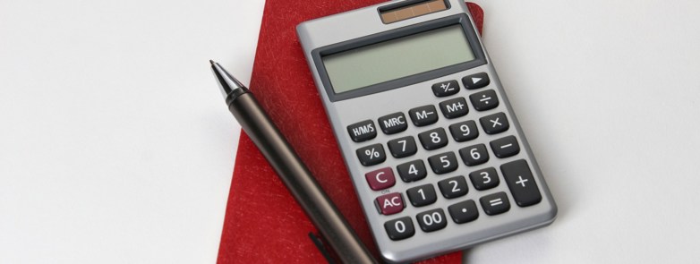 Calculating equipment in the office using books, calculators and pens