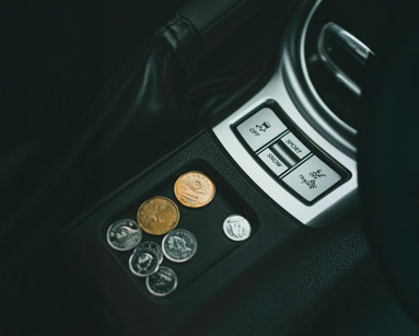 A Few Coins on a Car's Coin Tray