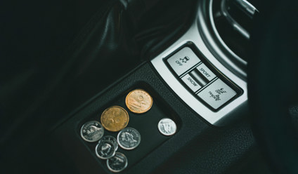 A Few Coins on a Car's Coin Tray