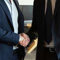 two business partners shaking hands in agreement
