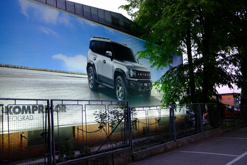 white suv advertisement on a large building