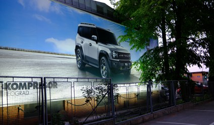 white suv advertisement on a large building