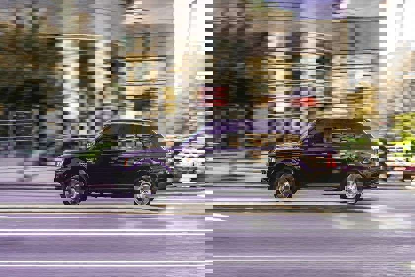 Black range rover driving in a city