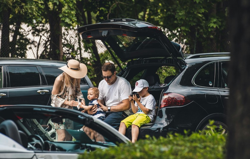 a group of people sitting in the trunk of a car