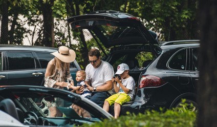 a group of people sitting in the trunk of a car