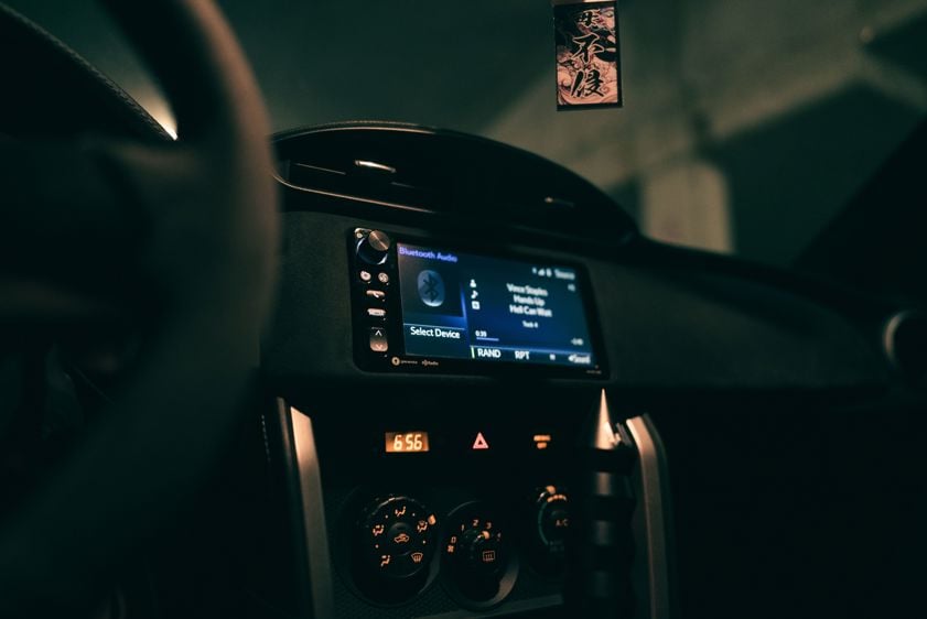 car dashboard showing an audio system display in a dimly lit interior