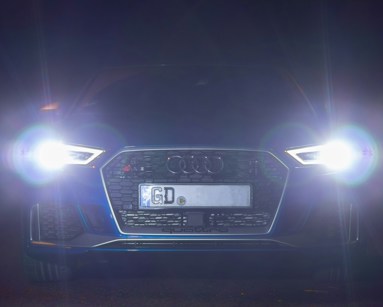 Audi car with headlights on in the dark