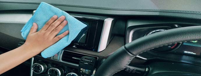 woman cleaning inside of car