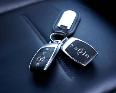 Black Mercedes car keys on a seat