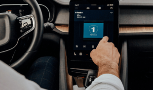 person using portrait touchscreen display in car