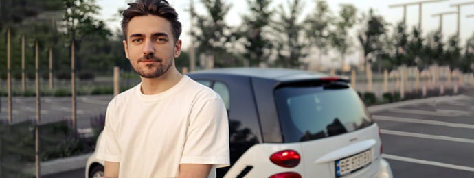 Young driver in front of their new car