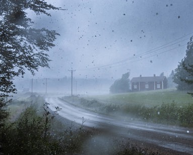 Rain storm with a house and road in the distance