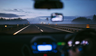 person driving on motorway at night