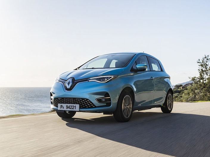 light blue renault zoe with driving on the seafront