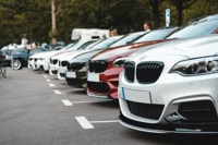 multiple BMW cars parked side by side in a car park