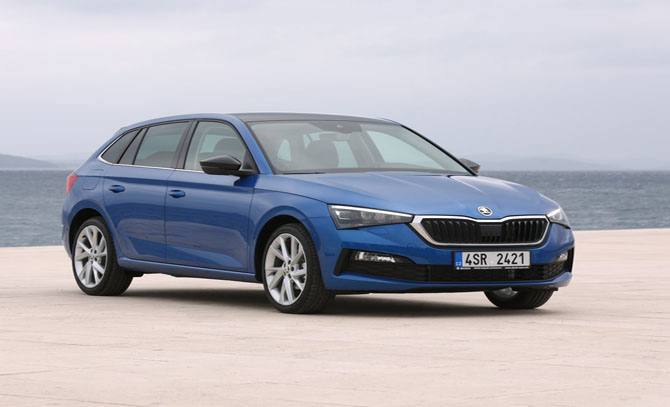 An image of the Skoda Scala, a small family car, parked on a scenic road with a sky in the background.