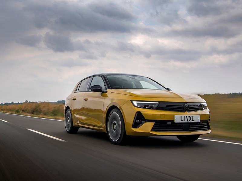 Yellow Vauxhall Astra on country road