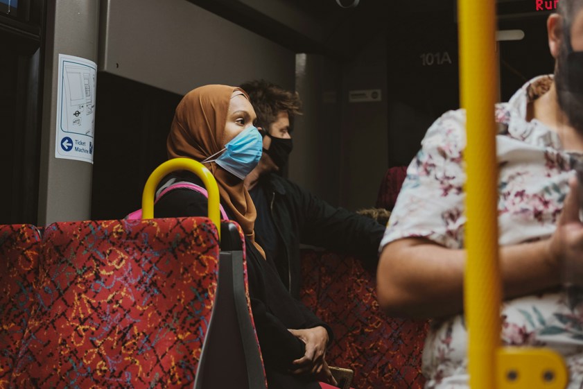 woman with a face mask on a bus