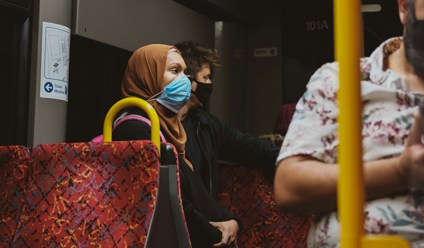 woman with a face mask on a bus