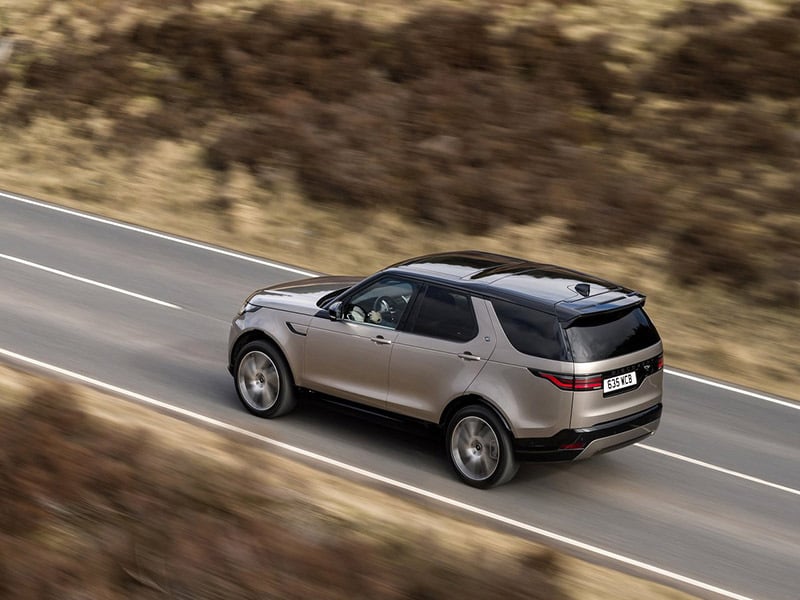 aerial shot of a range rover discovery driving on the road