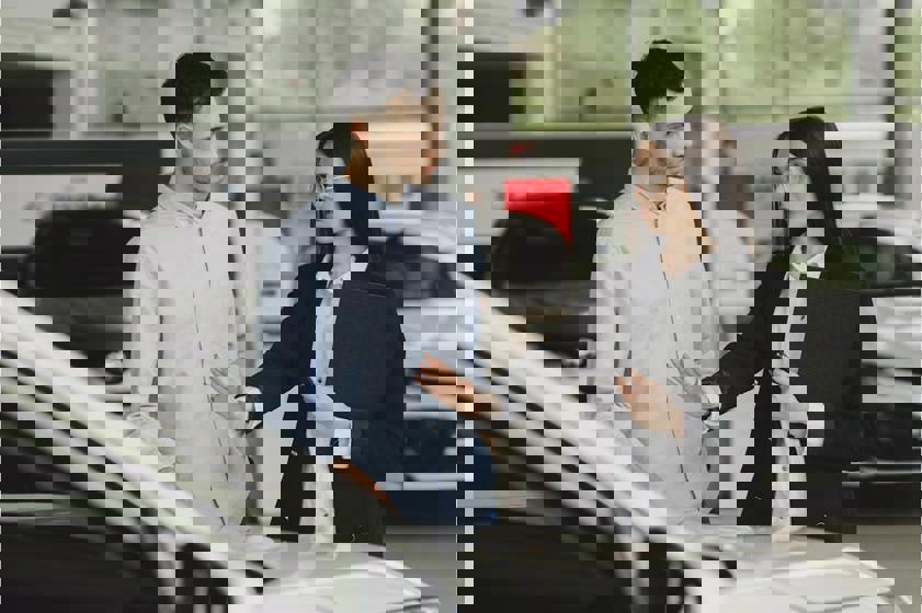Man and woman looking at a car